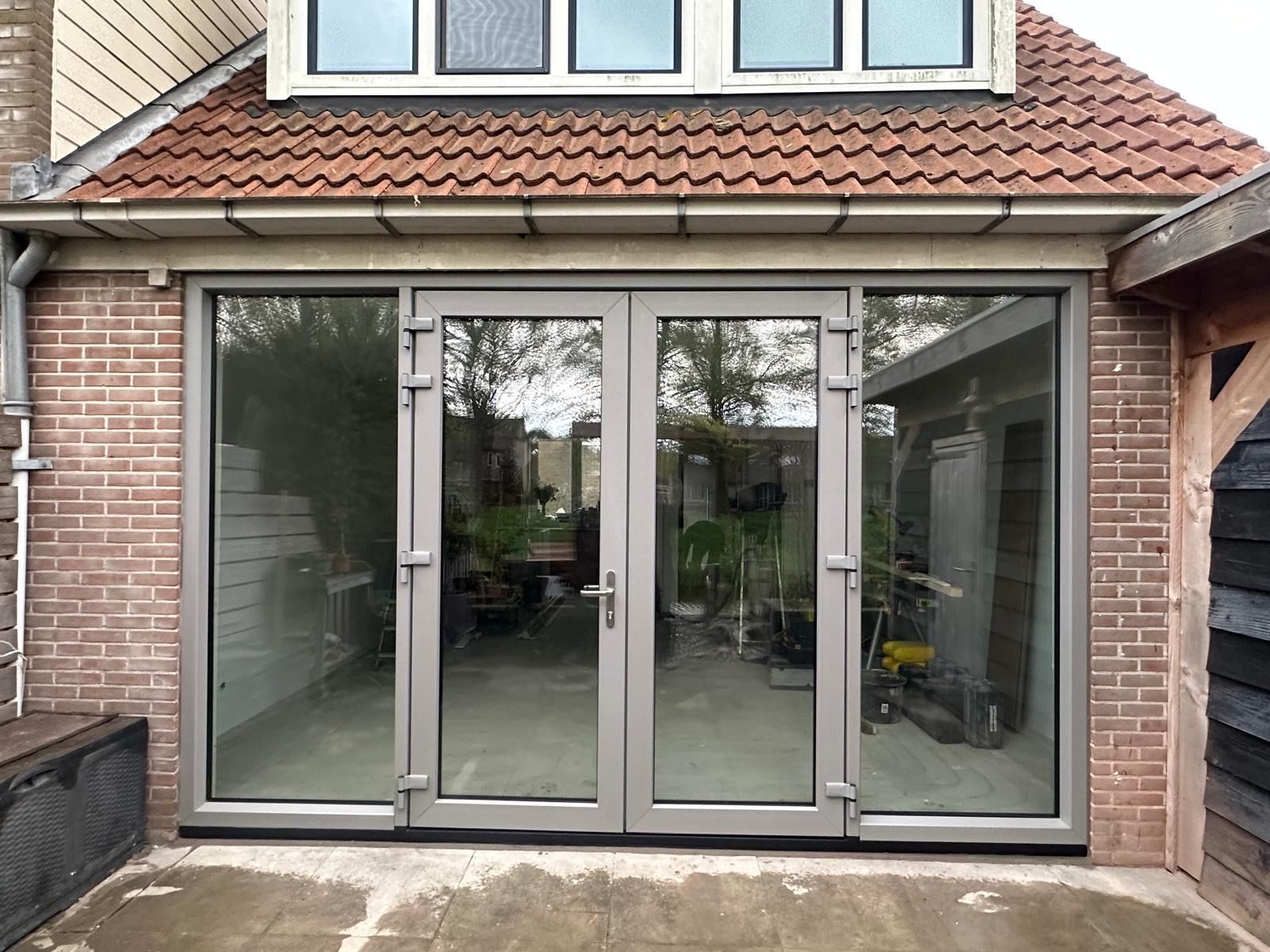 Openslaande kunststof tuindeuren met vaste zijlichten, grijs