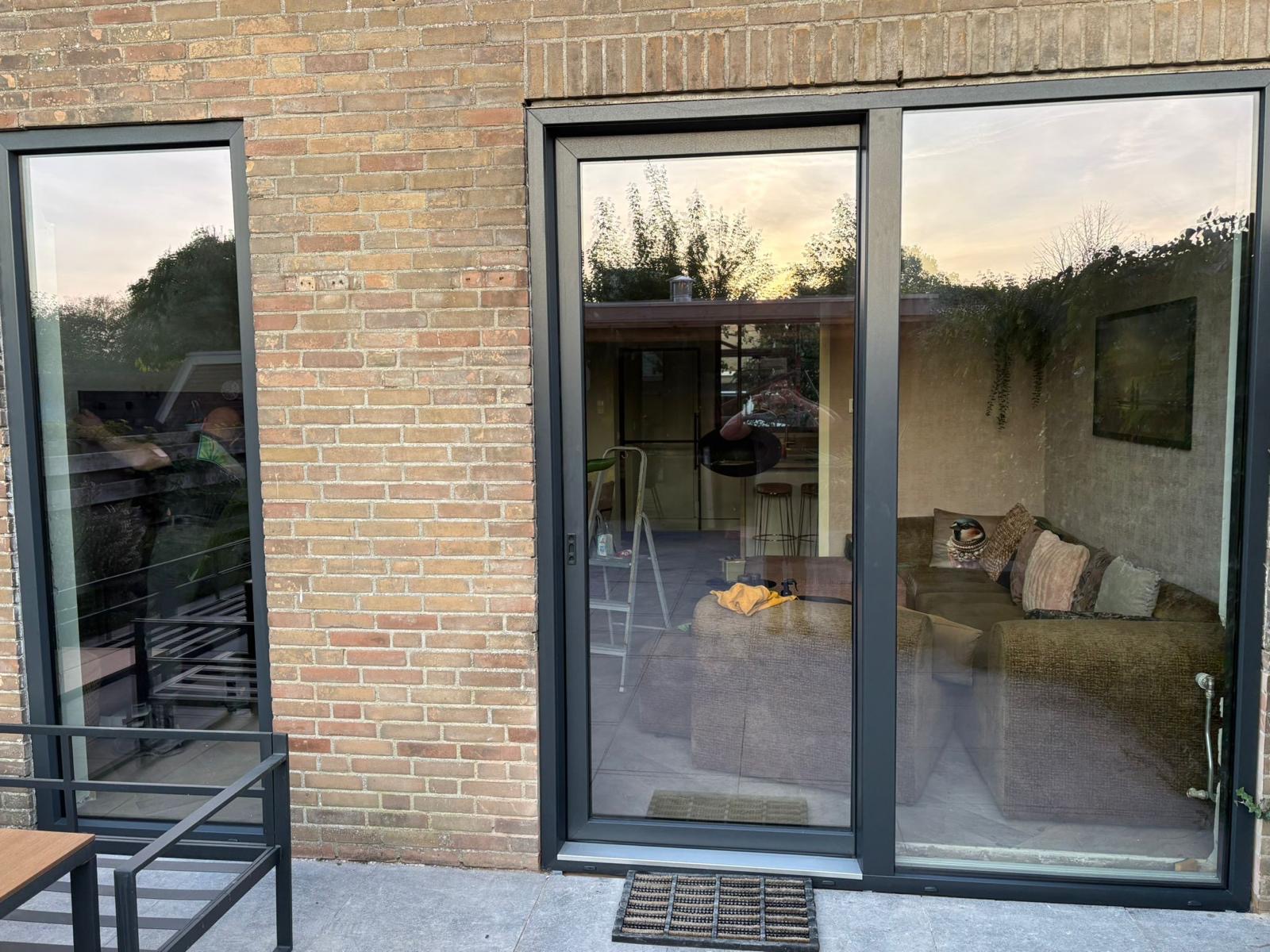 Terrasdeur met vast glas in antraciet, avondlicht